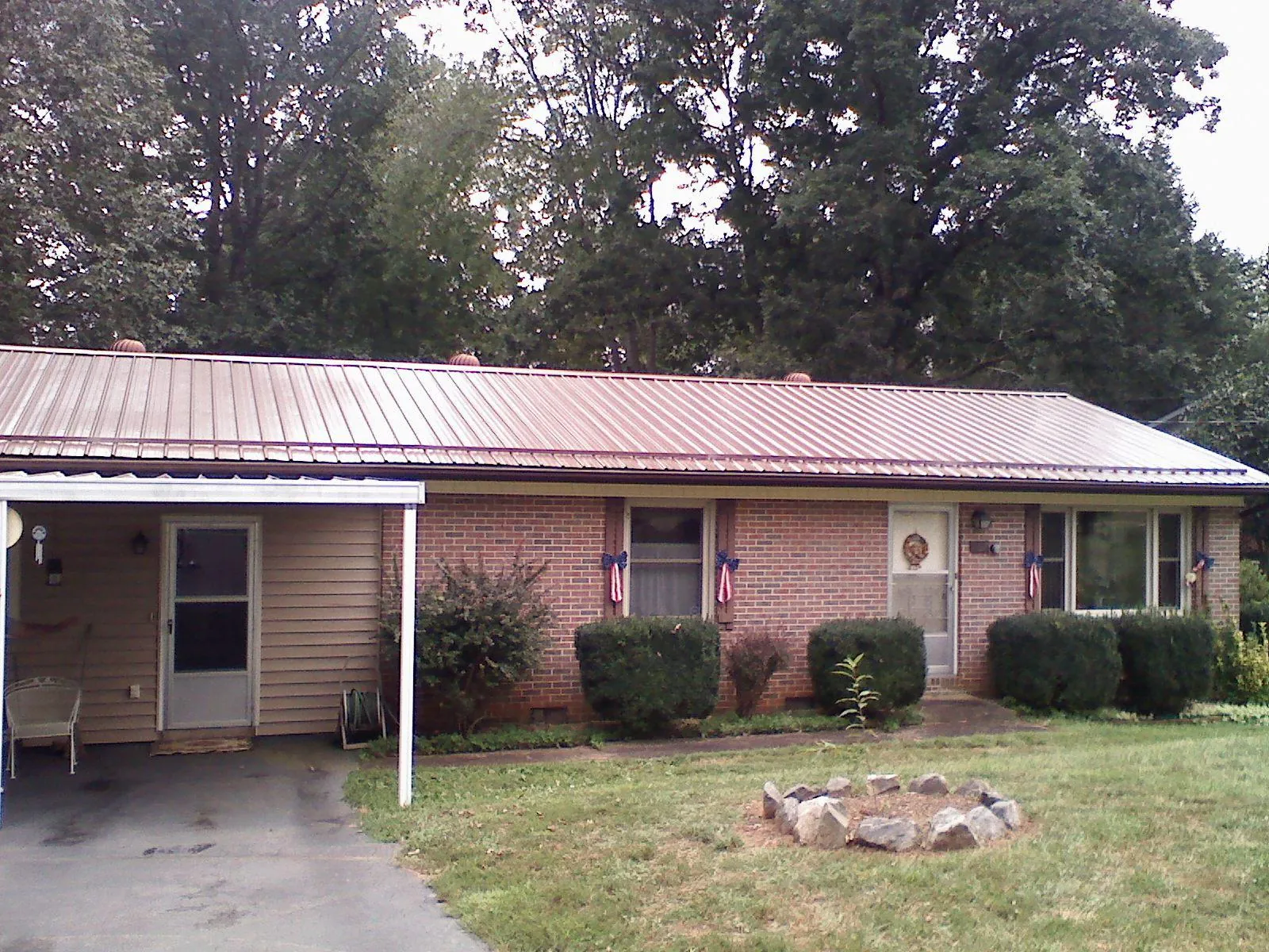 Bronze metal roof and carport on a brick ranch home — Roof Repair work by our crew in Quarryville