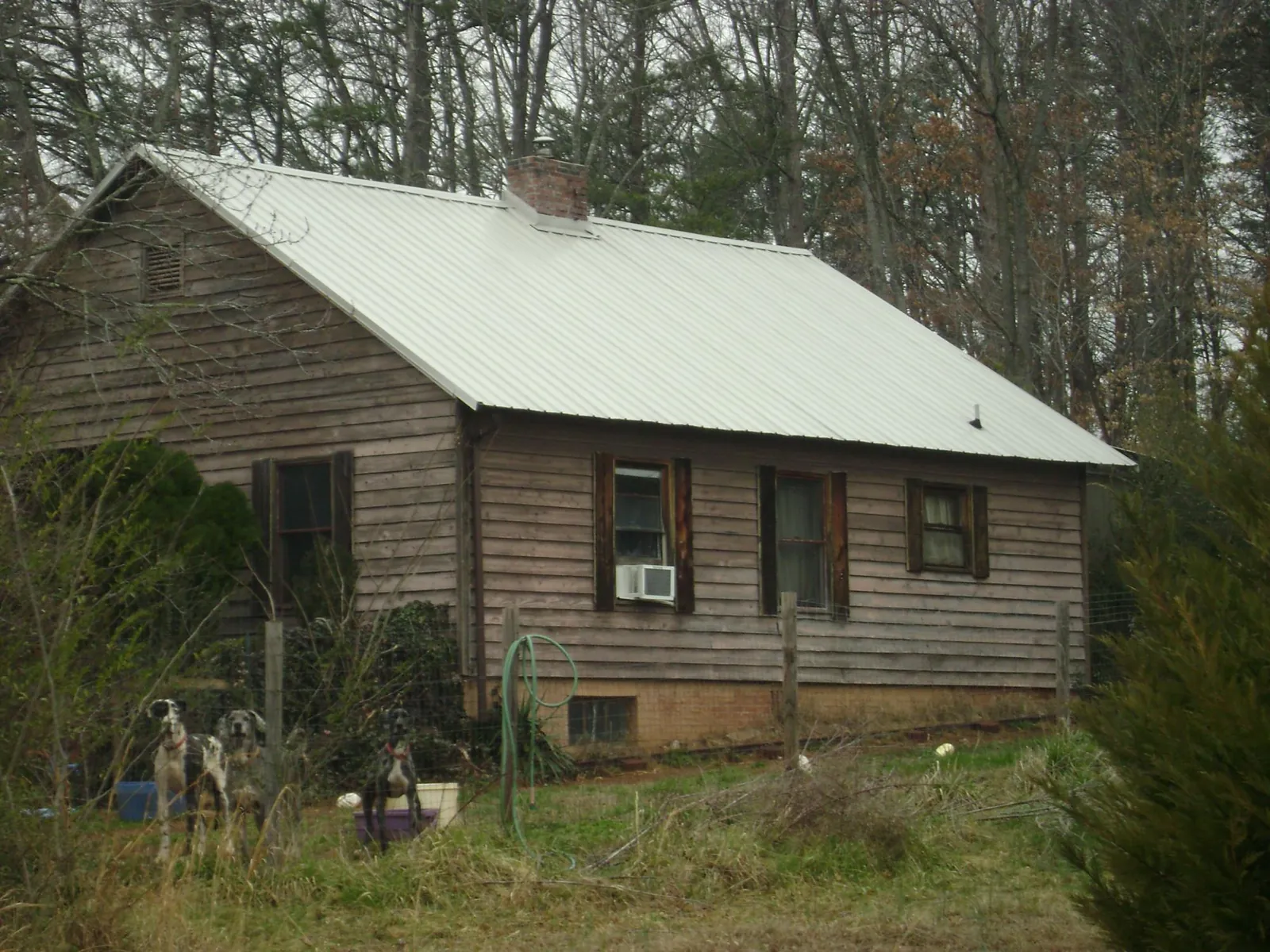 White metal roof on an old wood sided farmhouse, from a Metal Roof Installation job in Quarryville